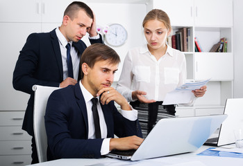 three worried coworkers different sexes in firm office