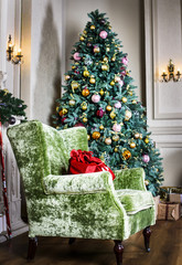 beautiful chair and Christmas tree with gifts