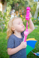 little girl is blowing a soap bubbles, Outdoor Portrait