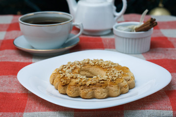 Homemade cookies in a plate on the feast of the new year, christmas. Tasty cookies on a table with a Christmas tree in the background. Tea.