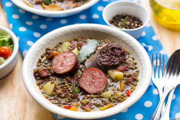 Lentil stew with carrots, potato, bell pepper and sausages