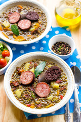 Lentil stew with carrots, potato, bell pepper and sausages