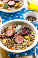 Lentil stew with carrots, potato, bell pepper and sausages