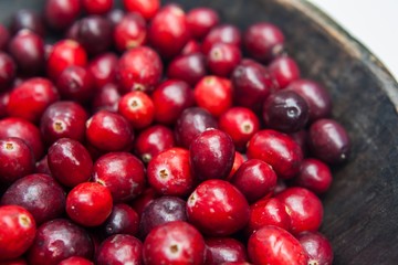 Fresh cranberries in wooden bowl