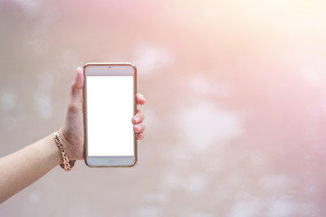 Beautiful young woman's hand using smart phone,flare light