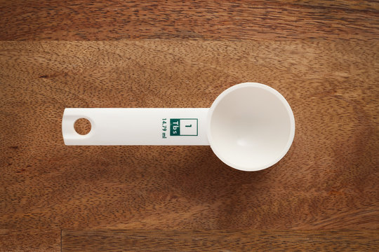 measuring spoon on wooden background