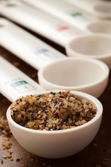 measuring spoons in varying sizes on wooden background