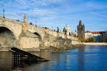 Obraz premium Vltava river and Charles Bridge, Prague, Czech Republic / Czechia - historic building from medieval age. Touristic landmark of the capital city
