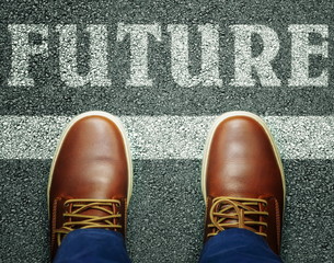 Man near inscription future on asphalt