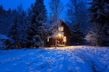 wooden house in winter forest
