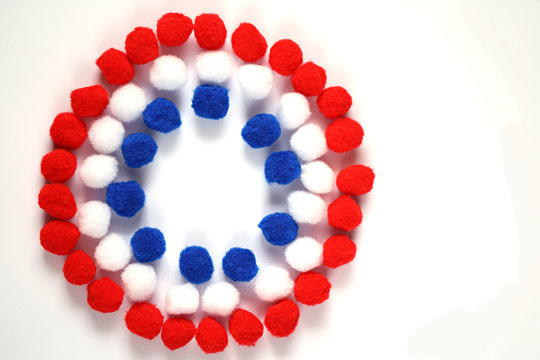 circle of blue, white, red small pompons  isolated on white background . tricolor