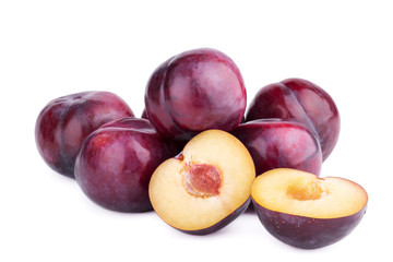 Group of plum fruits and a half  on white background