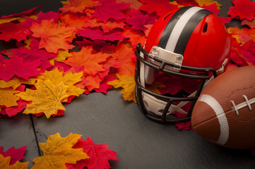 Thanksgiving american football game concept with copy space, a generic helmet and ball on the...