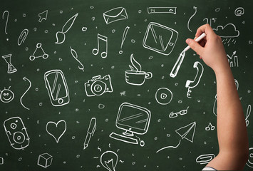 Hand writing icons on blackboard