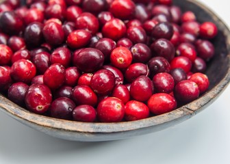 Fresh cranberries in wooden bowl