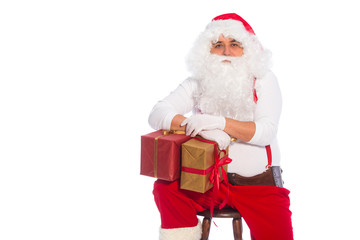 Portrait of happy Santa Claus holding Christmas gifts
