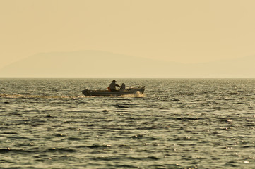 Old fisherman and the sea at the evening on peninsula Sithonia in Greece