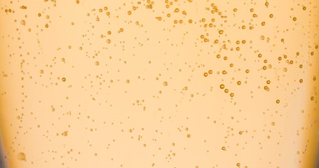 champagne golden bubbles inside a flute, gold background effect
