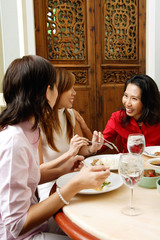 Three women in restaurant, talking