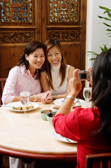Women posing for a picture on friends camera