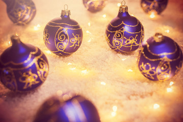 Blue decorative Christmas balls and lights in a snow