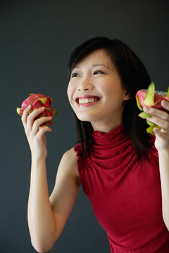 Woman holding cut dragon fruit