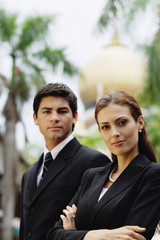Business people standing, looking at camera
