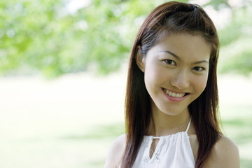 Young woman smiling at camera, head shot