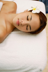 Obraz na płótnie Canvas Young woman massage table, eyes closed, head shot