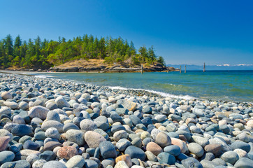 Majestic mountain lake with pebbles beach in Canada.