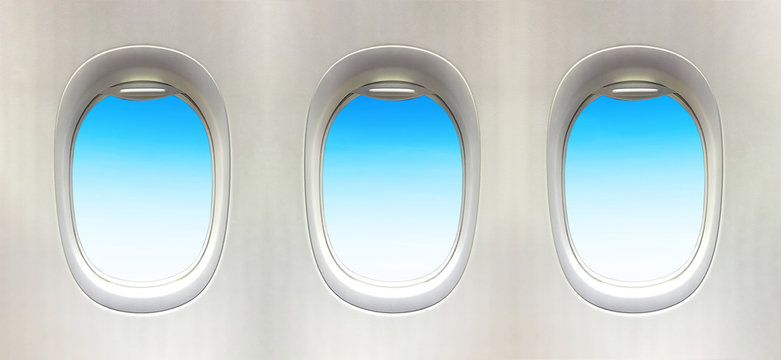 Airplane window and Fantastic soft white clouds against blue sky