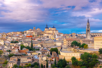 Fototapeta na wymiar Old city of Toledo with Primate Cathedral of Saint Mary, churches of San Ildelfonso, San Roman and Santo Tome at sunset, Castilla La Mancha, Spain.