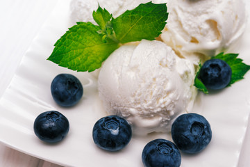 Vanilla ice cream with mint and blueberry  in white plate