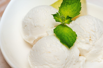 Close up of ice-cream with   mint and melon  in white plate