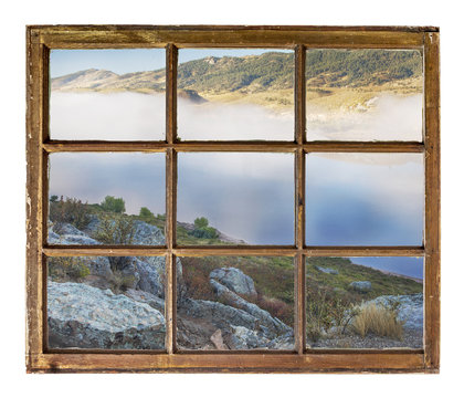 Fototapeta window view - valley and lake in fog