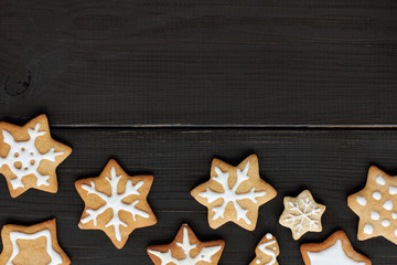 delicious festive Starfall/ flat layout of the cookies in the form of stars and snowflakes on dark wooden surface top view