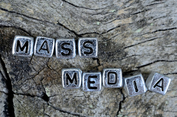 cube word mass media on table