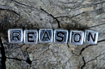 cube word reason on wooden table