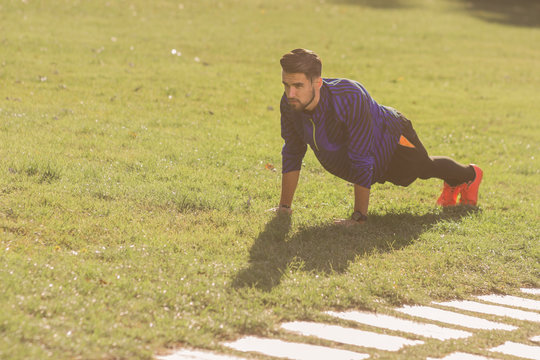 young man athlete football player, push ups exercise