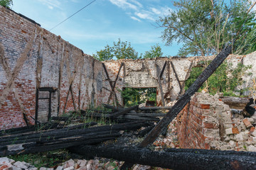 abandoned Warehouse with a crumbling roof and charred wooden logs in Samara