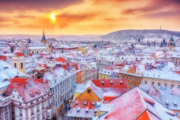 Poster Prague in Christmas time, classical view on snowy roofs in central part of city. © Feel good studio