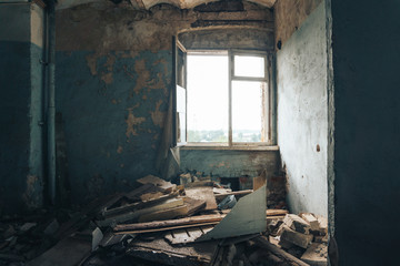 habitation of homeless man inside in abandoned house. Peeling walls