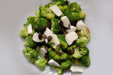healthy lunch, broccoli with fresh mozzarella and pumpkin seeds