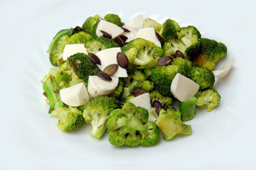healthy lunch, broccoli with fresh mozzarella and pumpkin seeds
