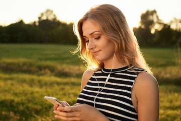 Portrait of a cute light-haired female who reads something on he