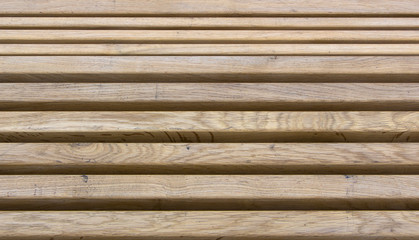 texture of a wooden fence with a new horizontal yellow bar
