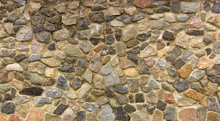 wall of granite boulders of different colors