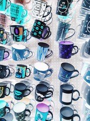 colorful mugs hanging on the white wall