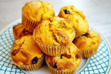Platter of homemade vegan pumpkin muffins with pears and dried cherries