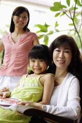 Three generations of females looking at camera